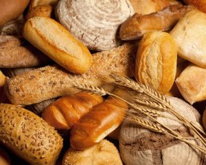 assortment of baked bread with wheat